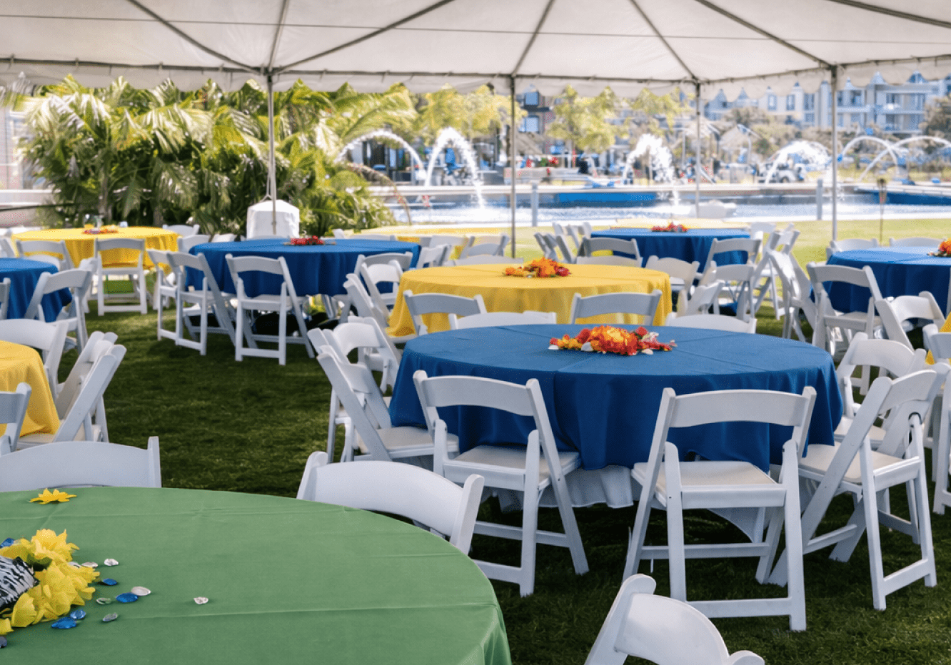 Tented outdoor event with colorful round tables