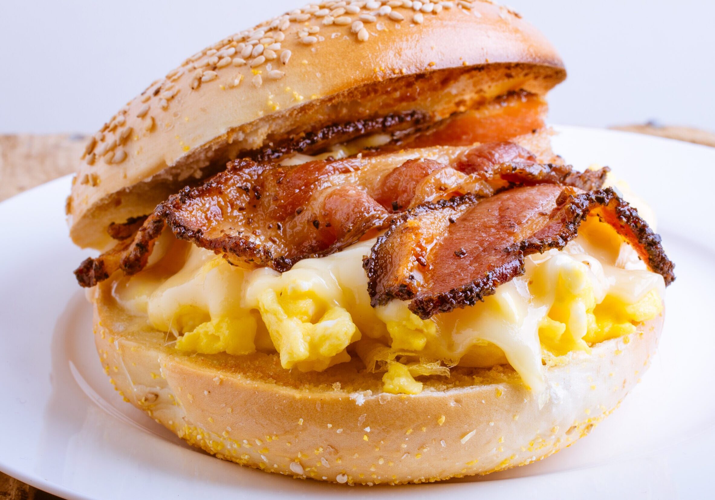 Sesame bagel with scrambled eggs and bacon