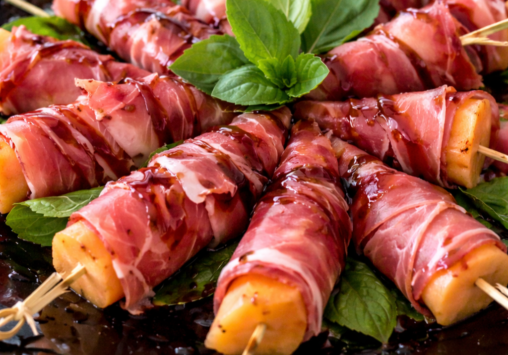 Prosciutto-wrapped melon skewers with basil