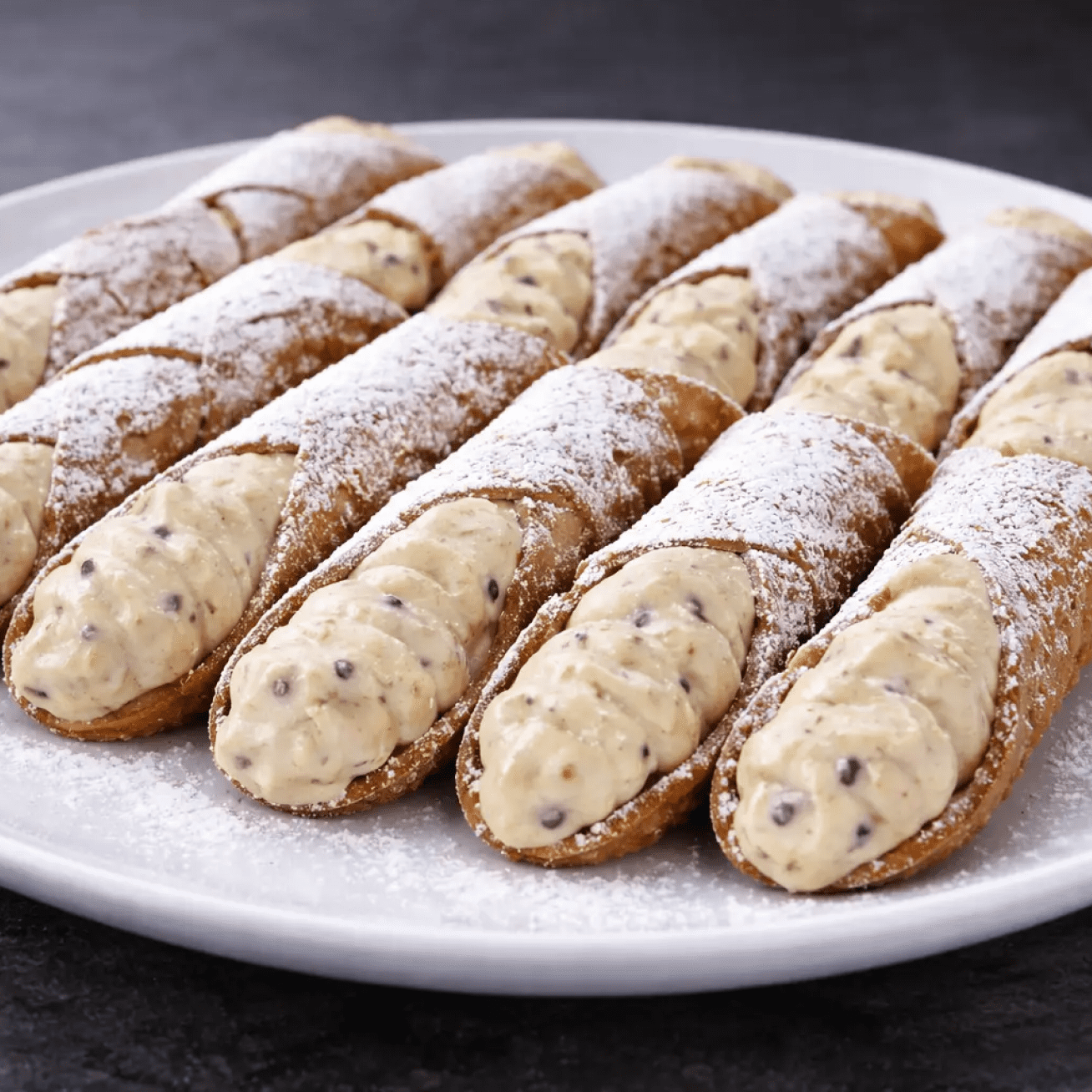 Chocolate chip cannoli dusted with powdered sugar